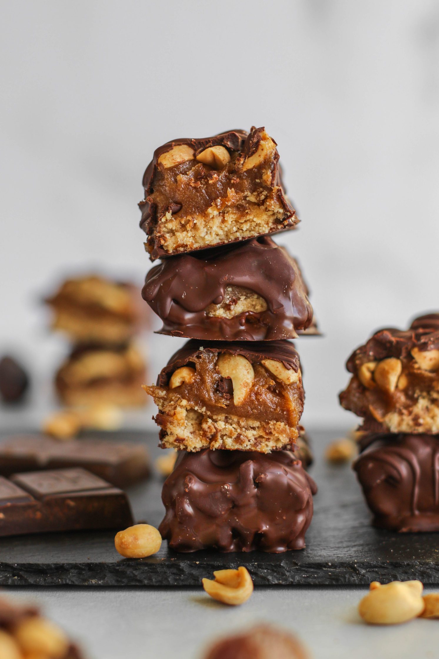 Vegan Salted Snickers Bars stacked on serving board by Flora & Vino 