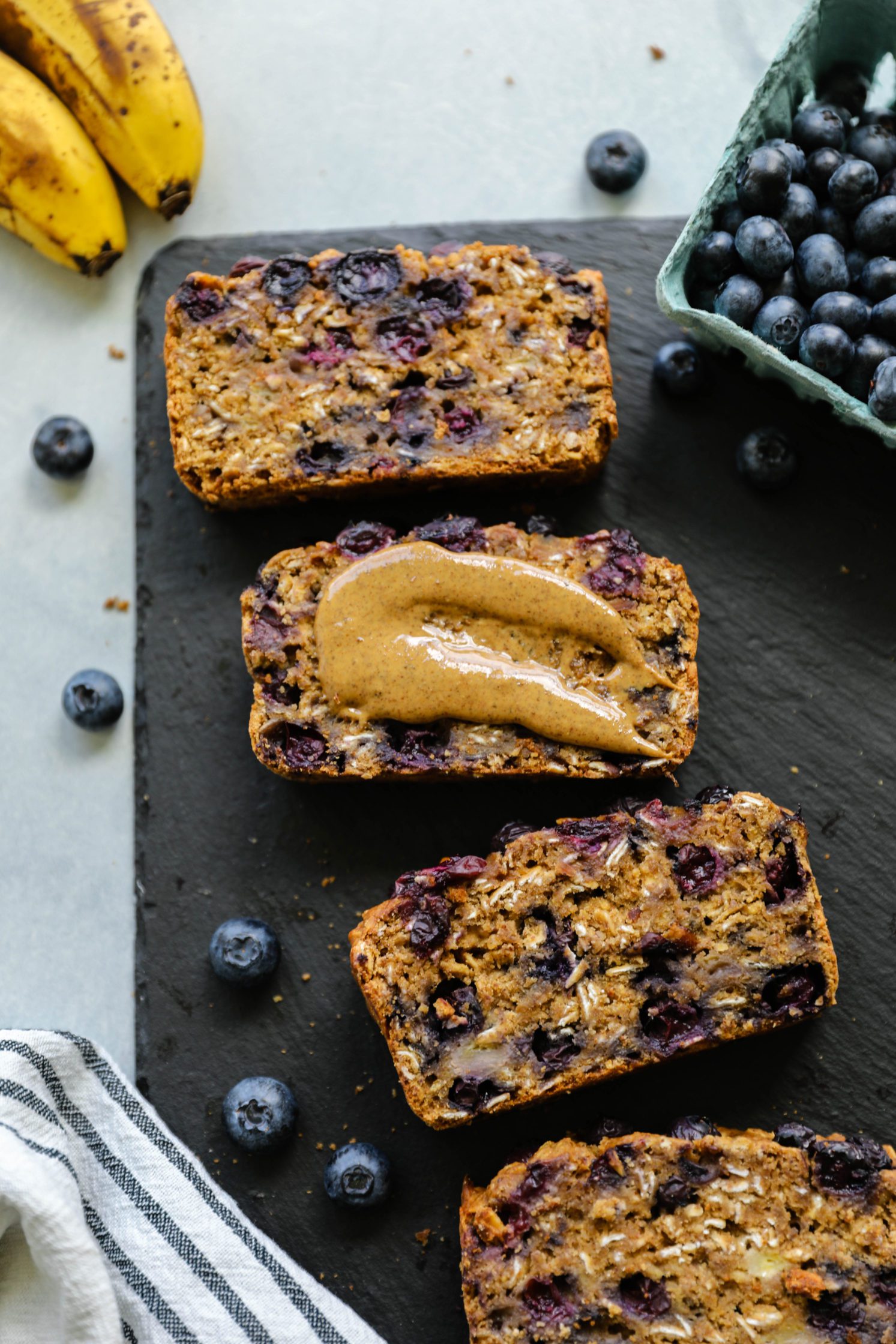 Blueberry Banana Breakfast Bread served on board with nut butter by Flora & Vino