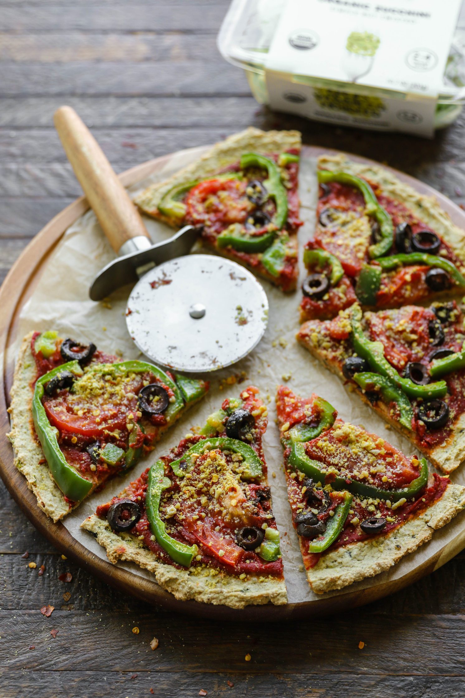Vegan Zucchini Crust Pizza sliced on round board