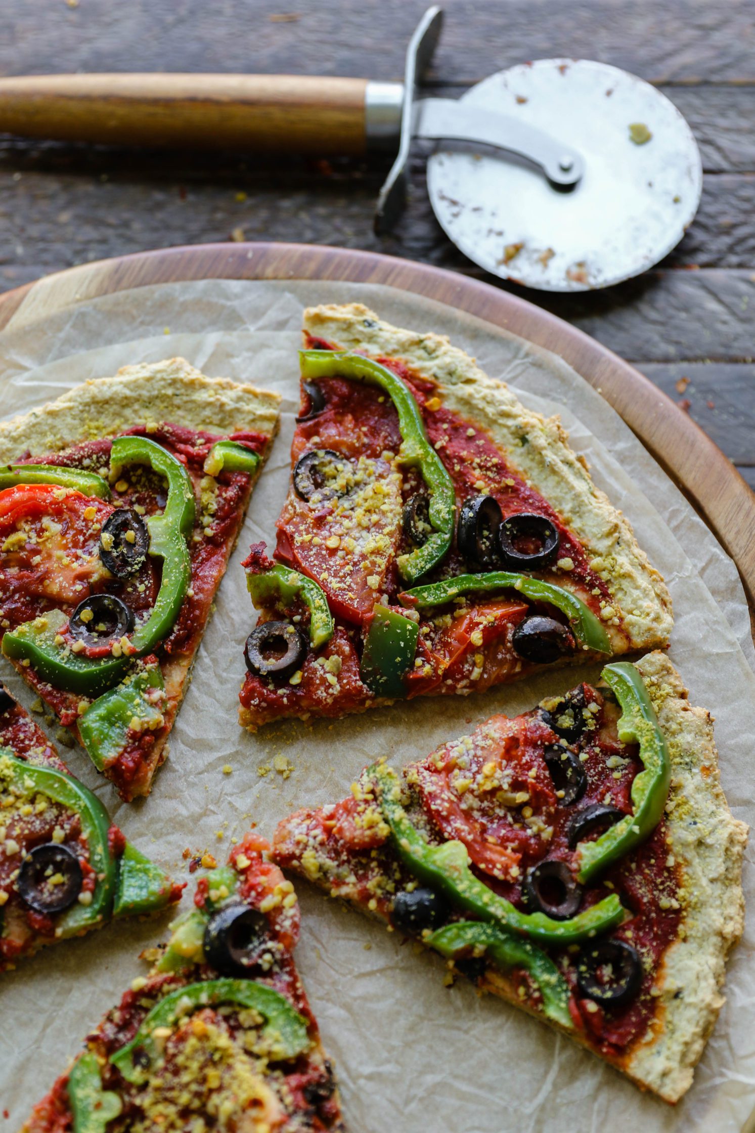 Vegan Zucchini Crust Pizza close up with pizza cutter