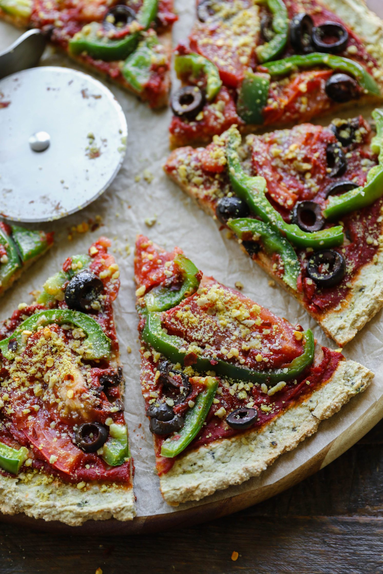 Vegan Zucchini Crust Pizza sliced on pizza board