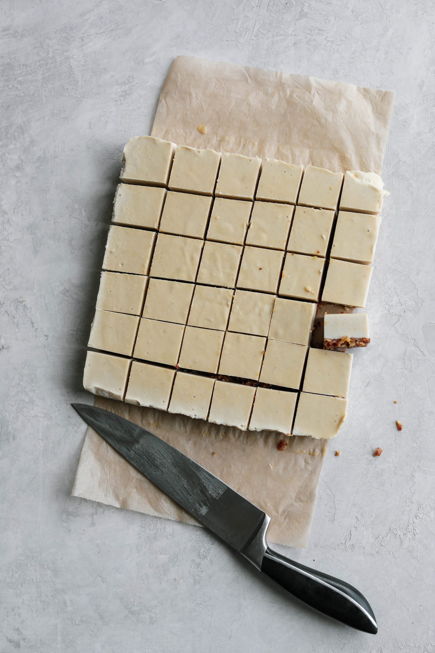 Chocolate Dipped Cashew Cheesecake Bites by Flora & Vino cut with knife