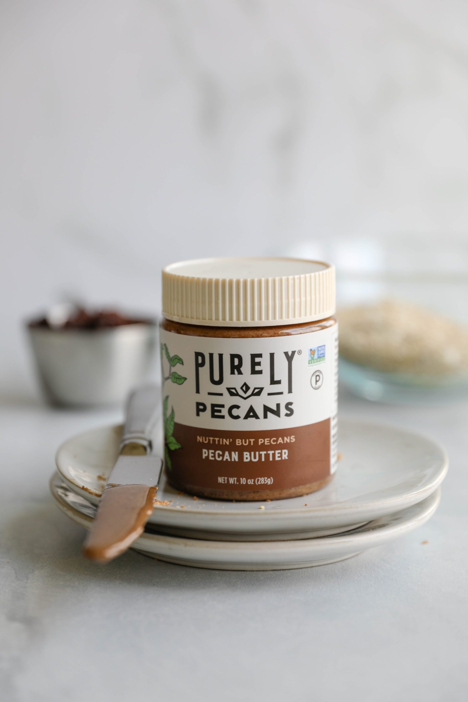 Purely Pecans Pecan Butter on plates by Flora & Vino