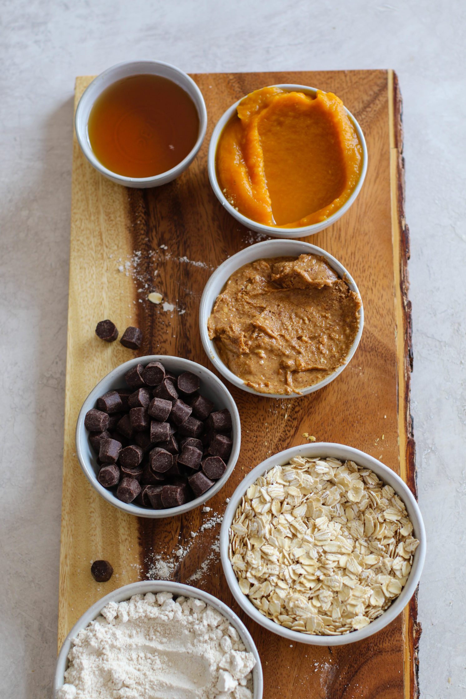 ingredients for pumpkin chocolate chip breakfast bars on wooden board