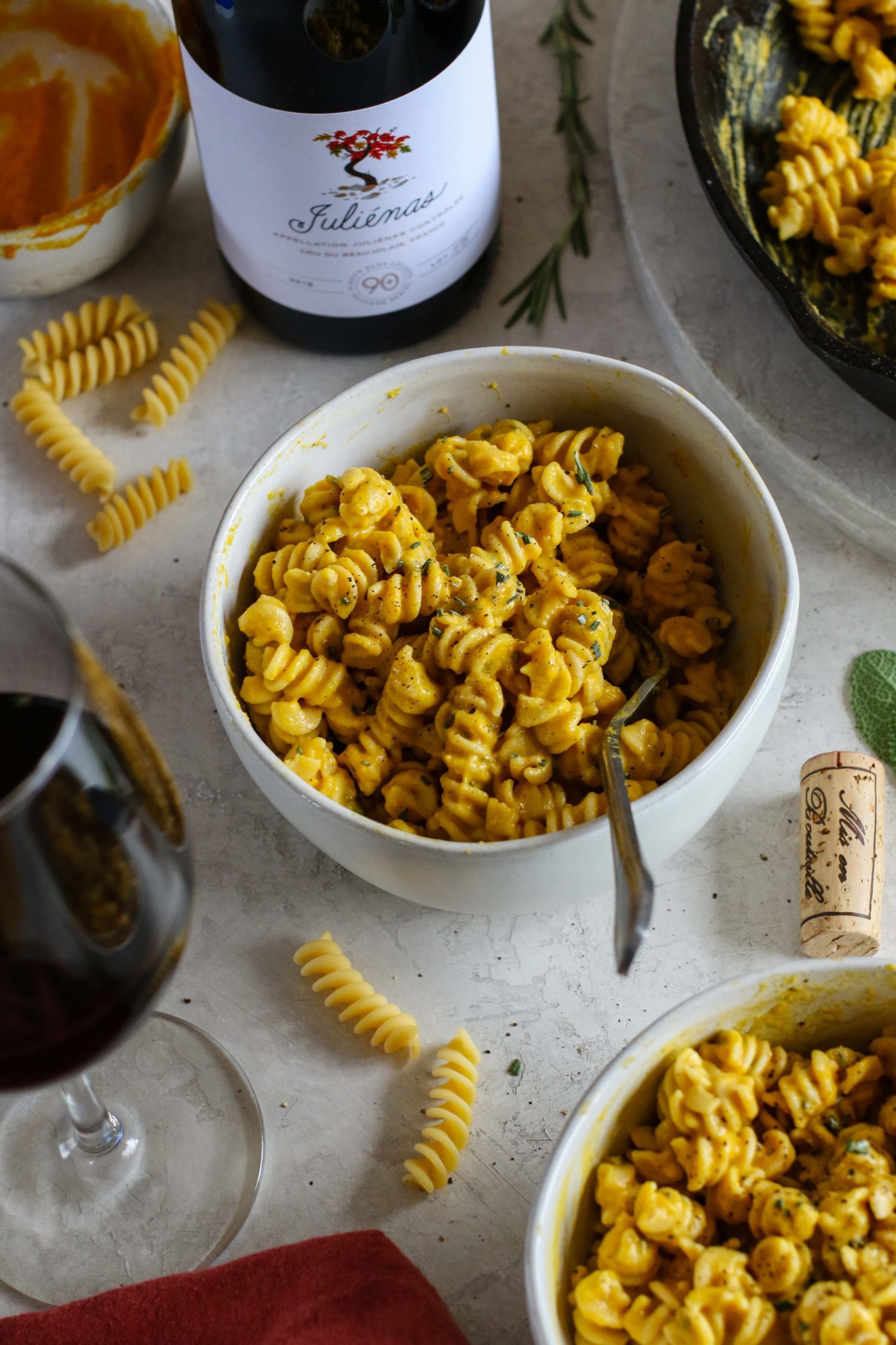 Creamy Vegan Pumpkin Pasta served in bowls with forks by Flora & Vino 