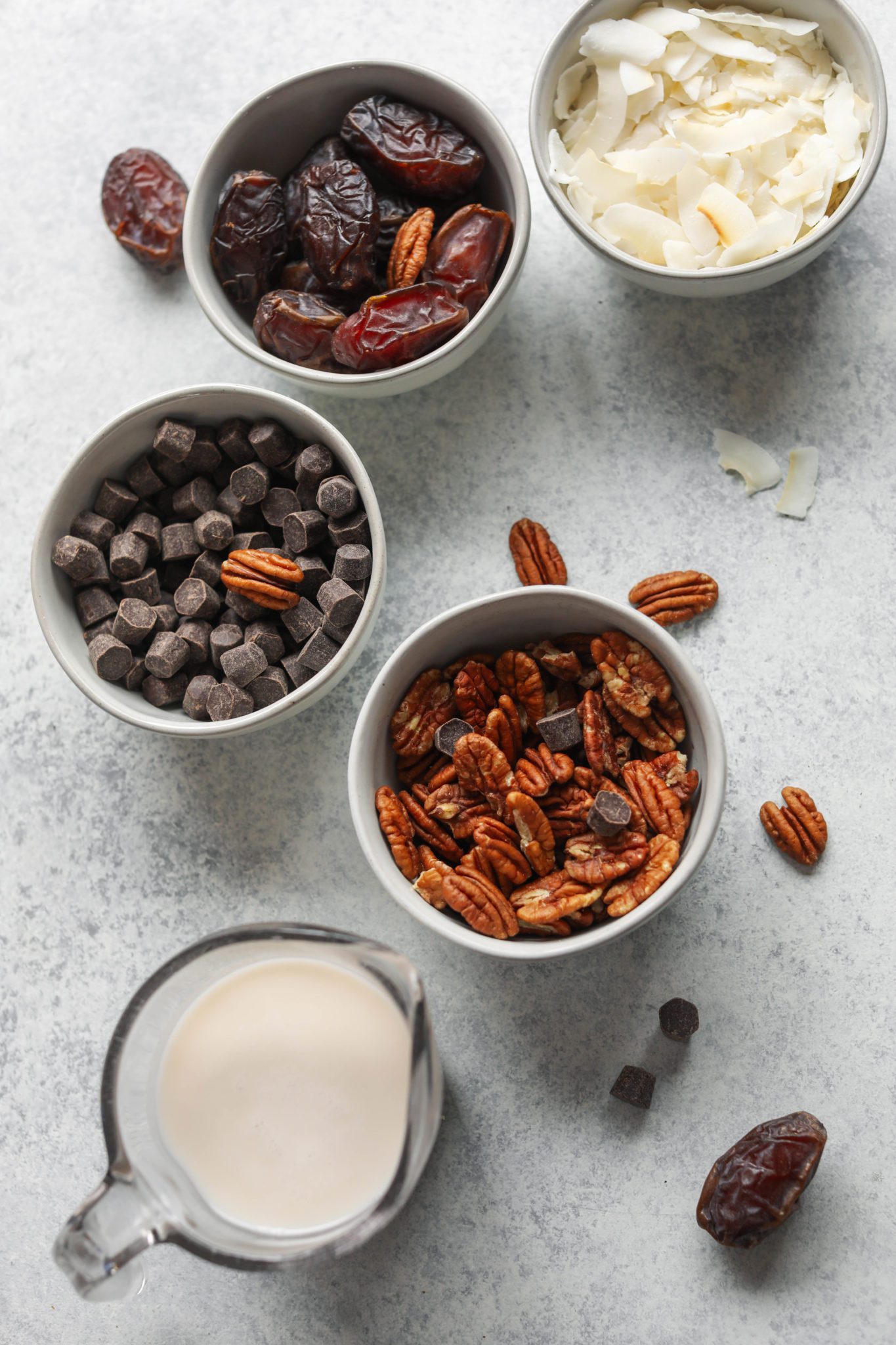 shredded coconut, Medjool dates, dark chocolate chips, pecans, and almond milk on board by Flora & Vino