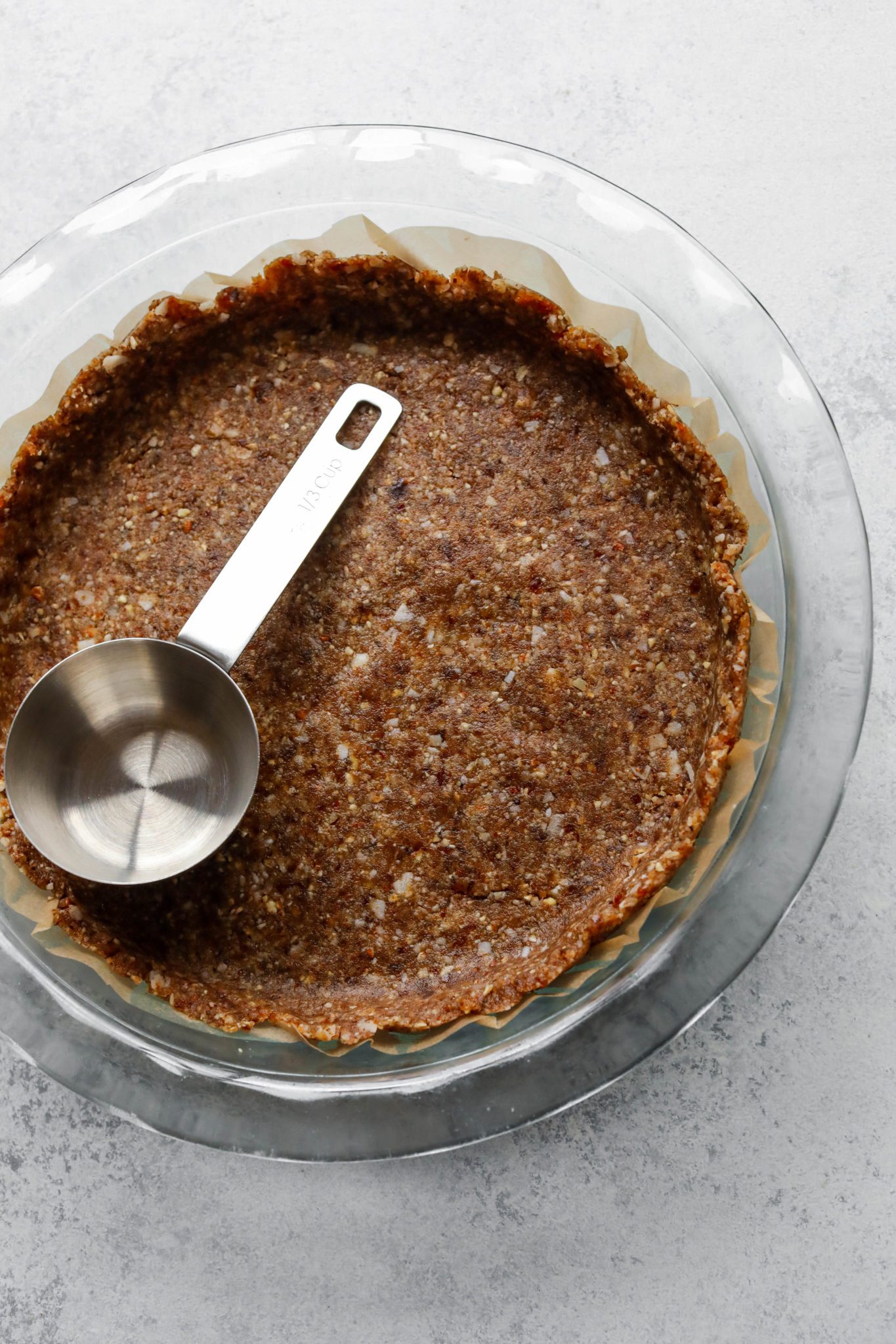 Grain-Free Crust in pie pan with parchment paper by Flora & Vino