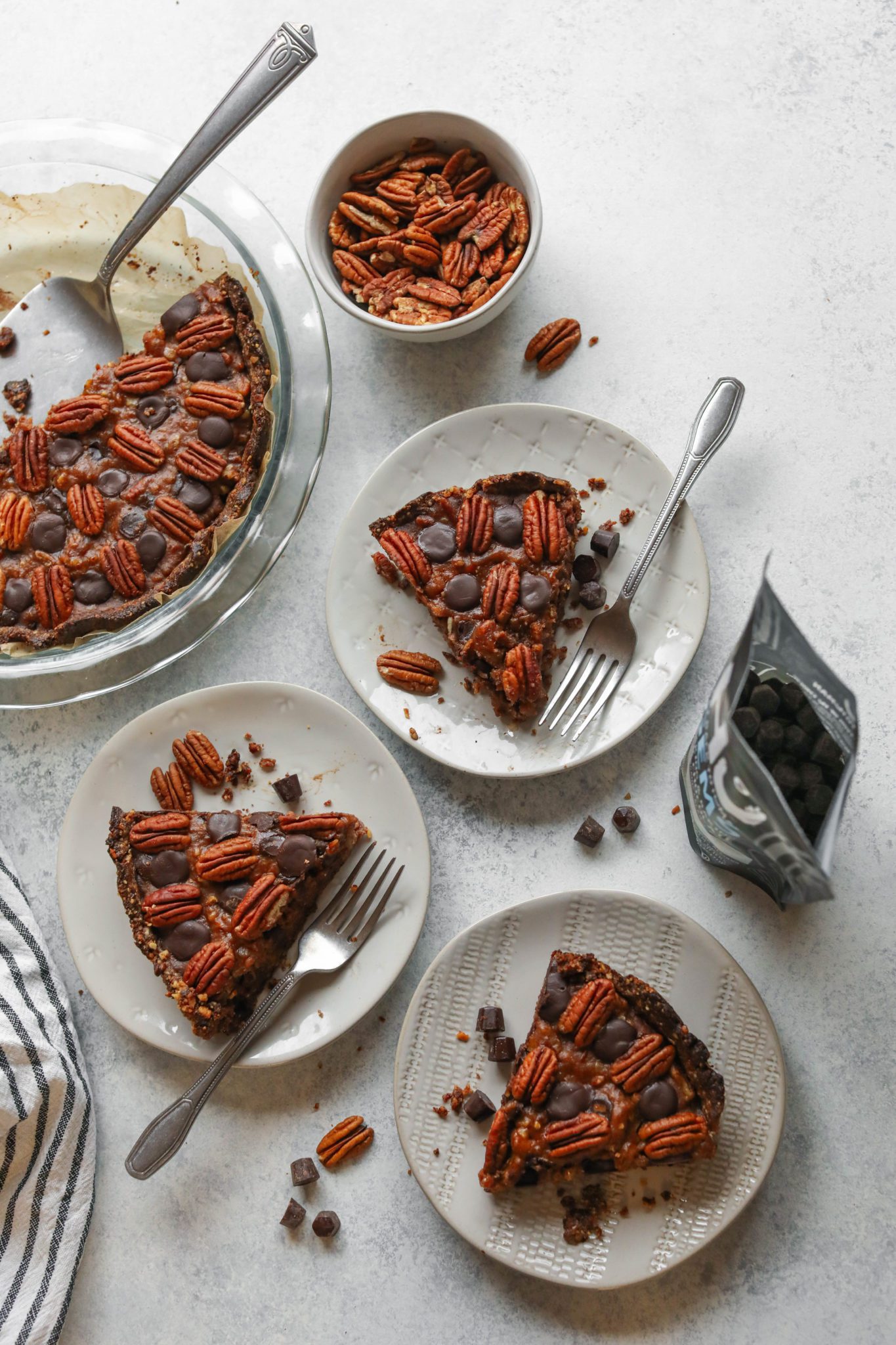 Vegan Dark Chocolate Pecan Pie sliced and plated with forks by Flora & Vino