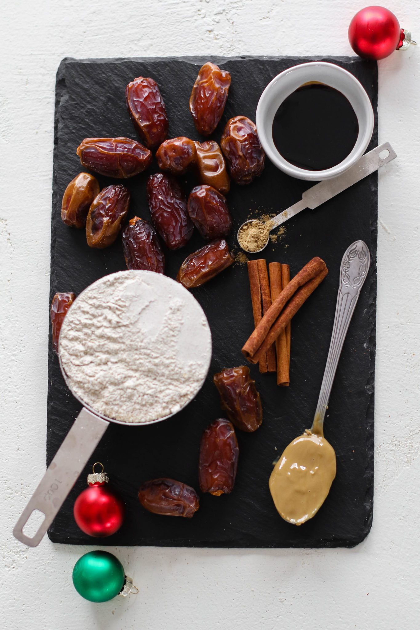 dates, oat flour, molasses, SunButter, and cinnamon on serving board by Flora & Vino