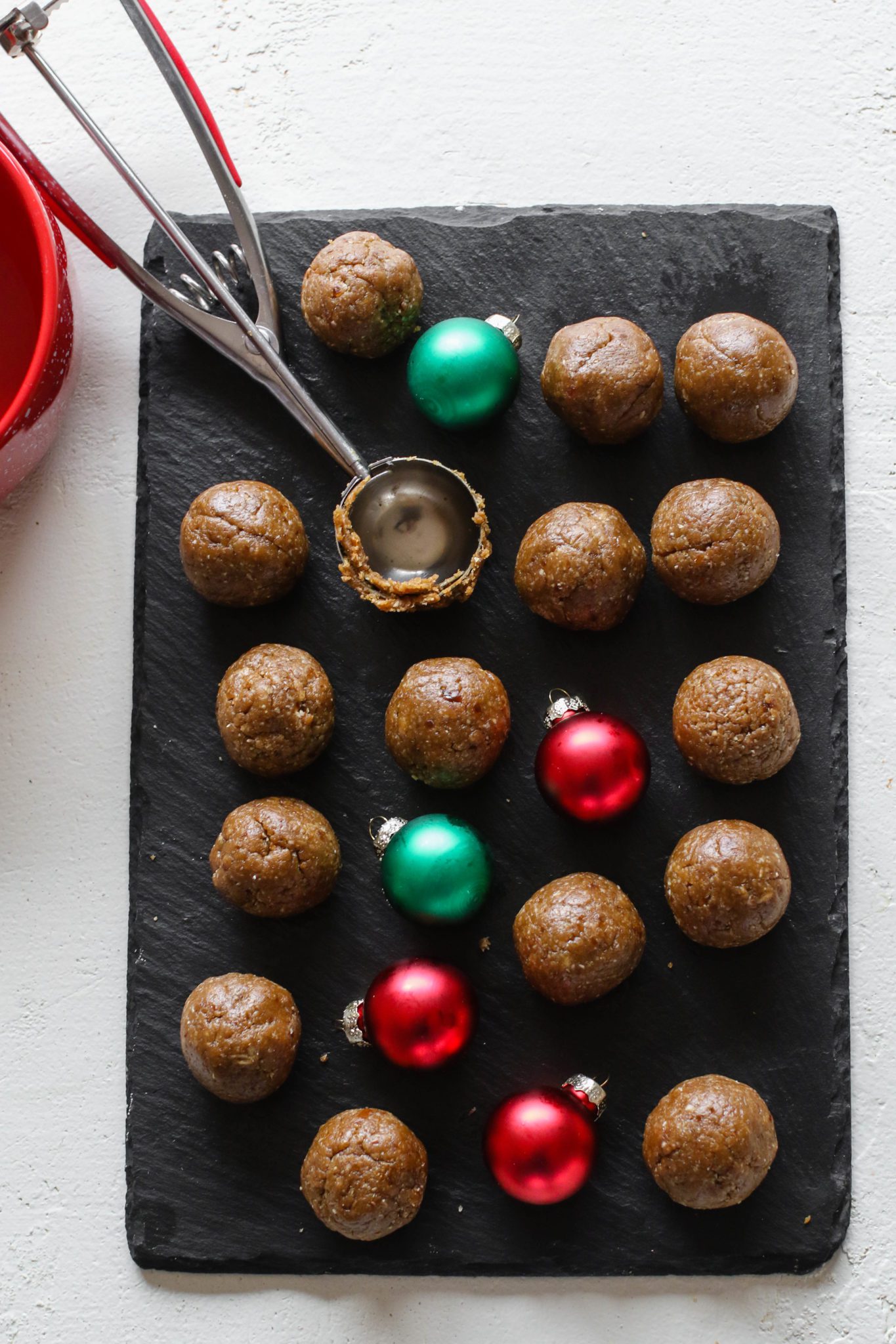 Gingerbread Balls Rolled out on serving board with cookie scoop by Flora & Vino