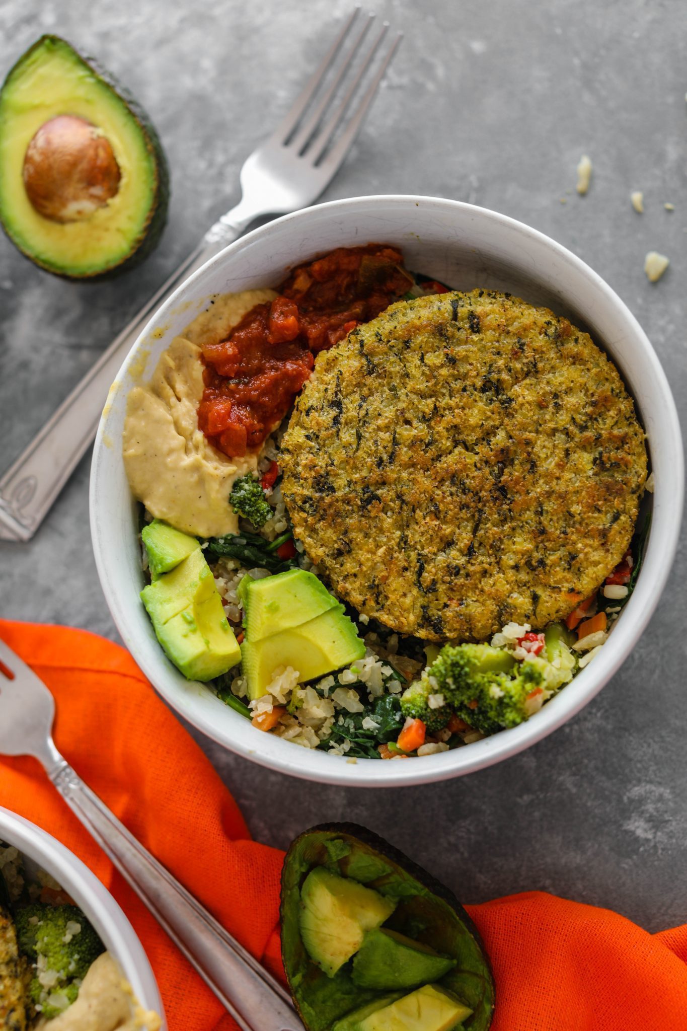 Cauliflower Rice Veggie Burger Bowl served in white bowl with avocado, hummus, and salsa