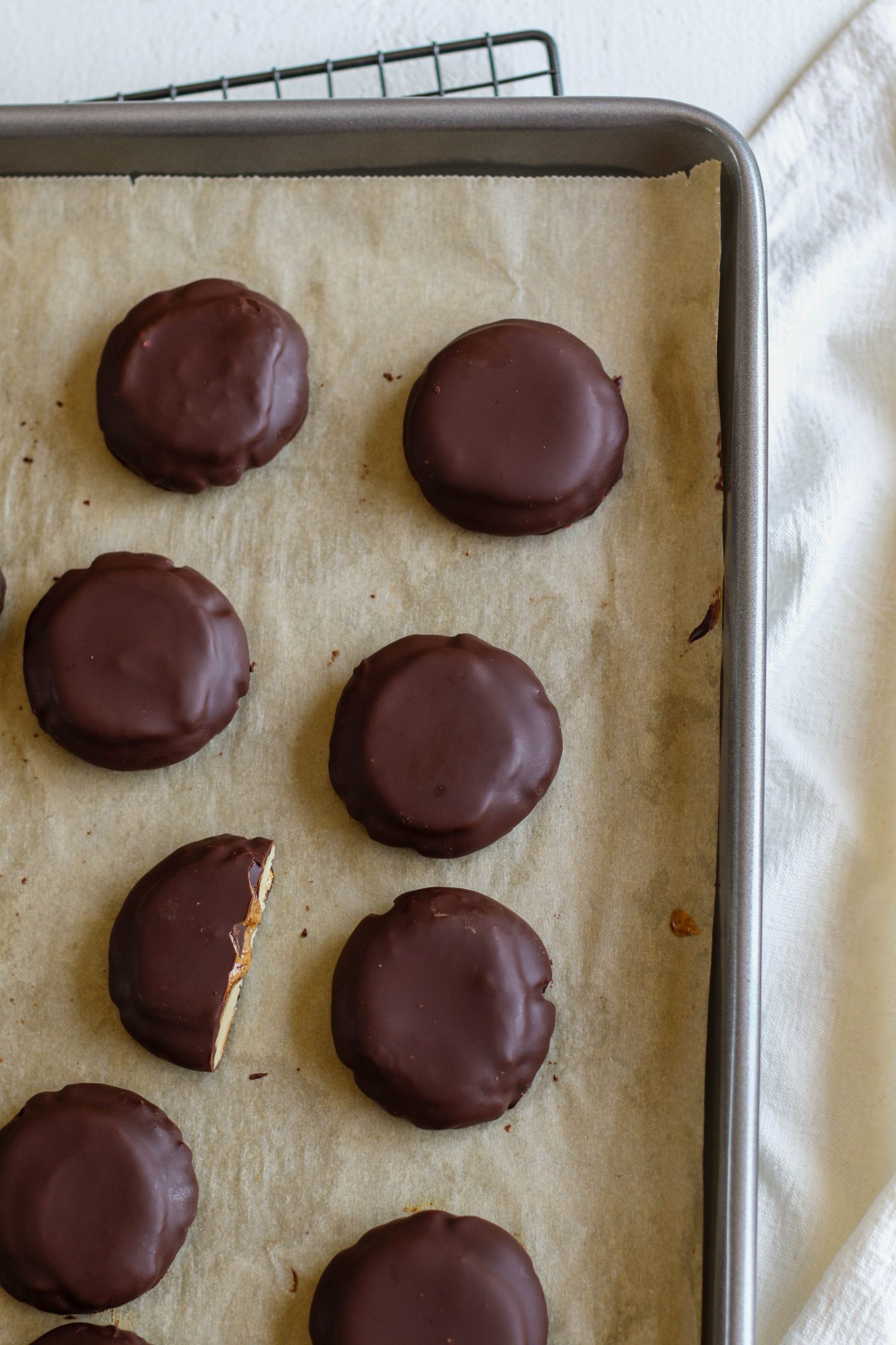 Vegan Almond Butter Tagalongs on parchment lined baking sheet