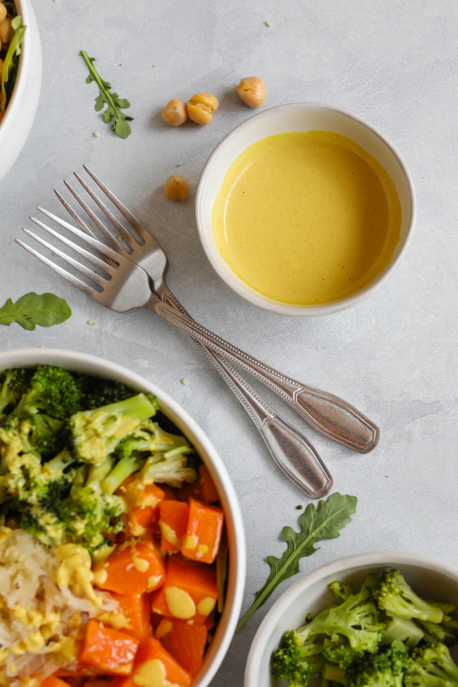 Chickpea Meal Prep Bowl served with Turmeric Tahini Dressing and forks by Flora & Vino 
