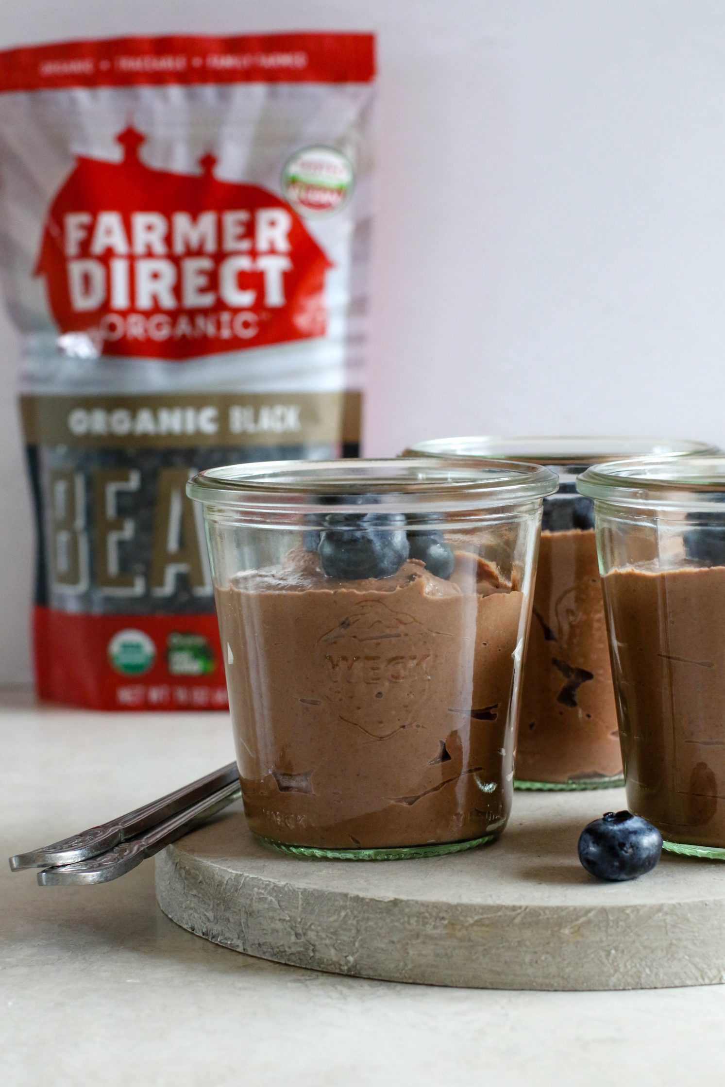 Black Bean Mousse served in mason jars with spoons by Flora & Vino 