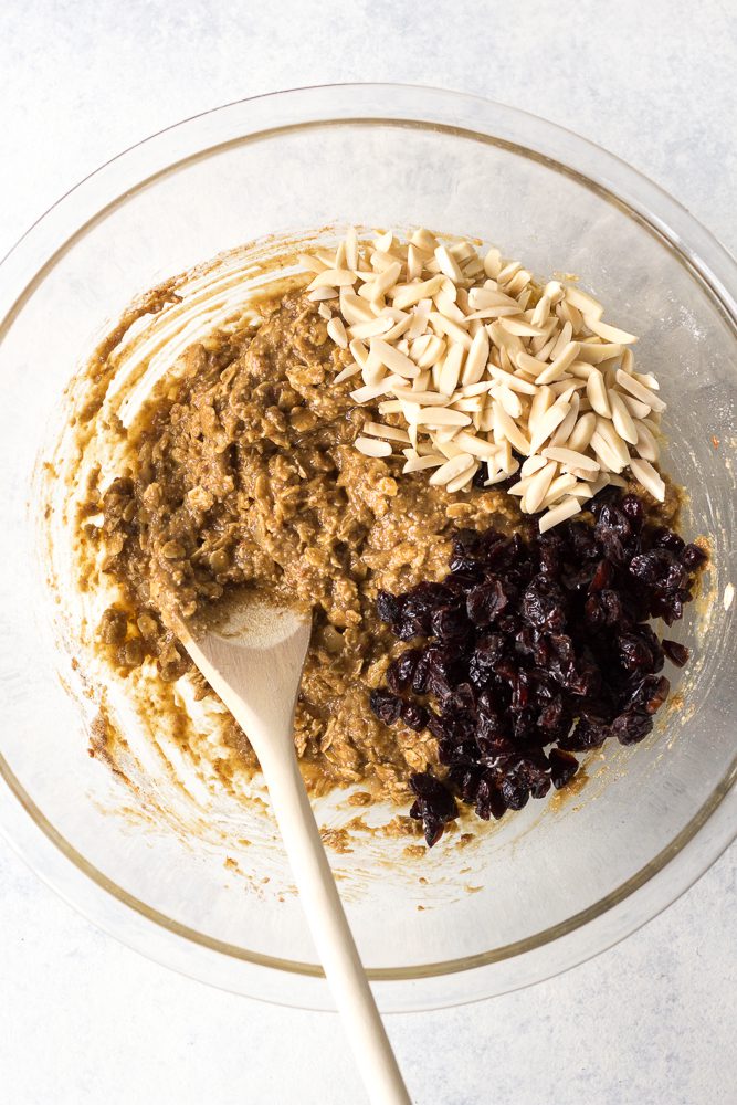 Cranberry Almond Breakfast Cookies mixed in bowl with wooden spoon by Flora & Vino