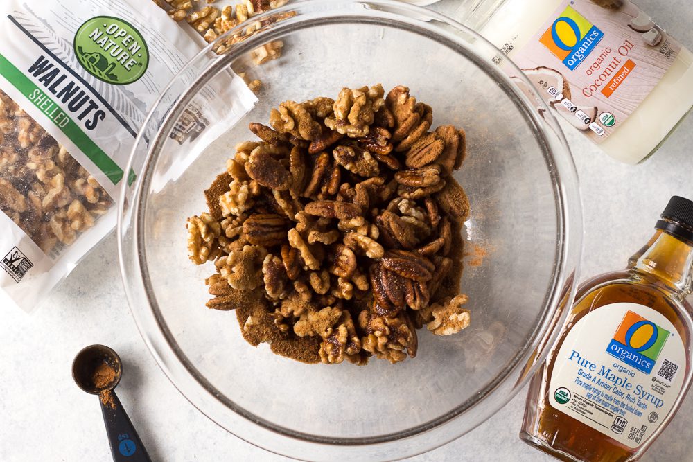 nuts in a bowl with cinnamon and maple syrup by Flora & Vino