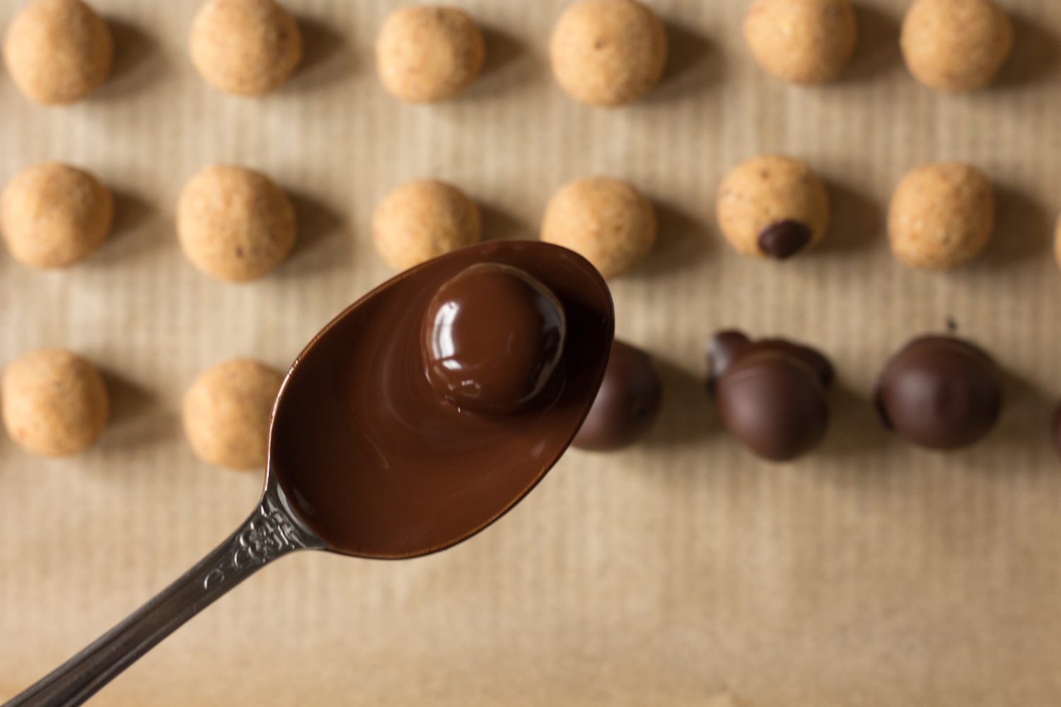 Vegan Peanut Butter balls dipped in melted dark chocolate by Flora & Vino