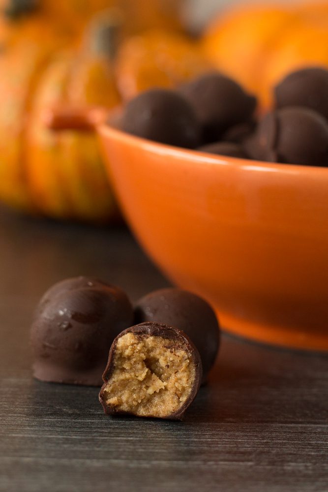 Vegan Peanut Butter Chocolate Balls with bite out of one by Flora & Vino
