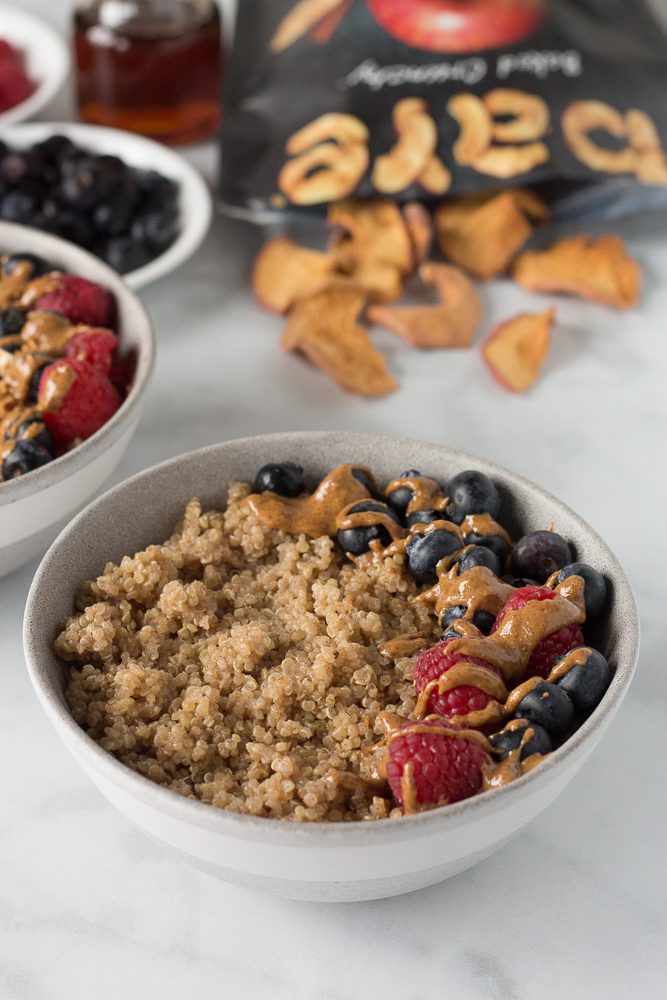 Coconut Quinoa Porridge served in bowl with berries and nut butter by Flora & Vino 