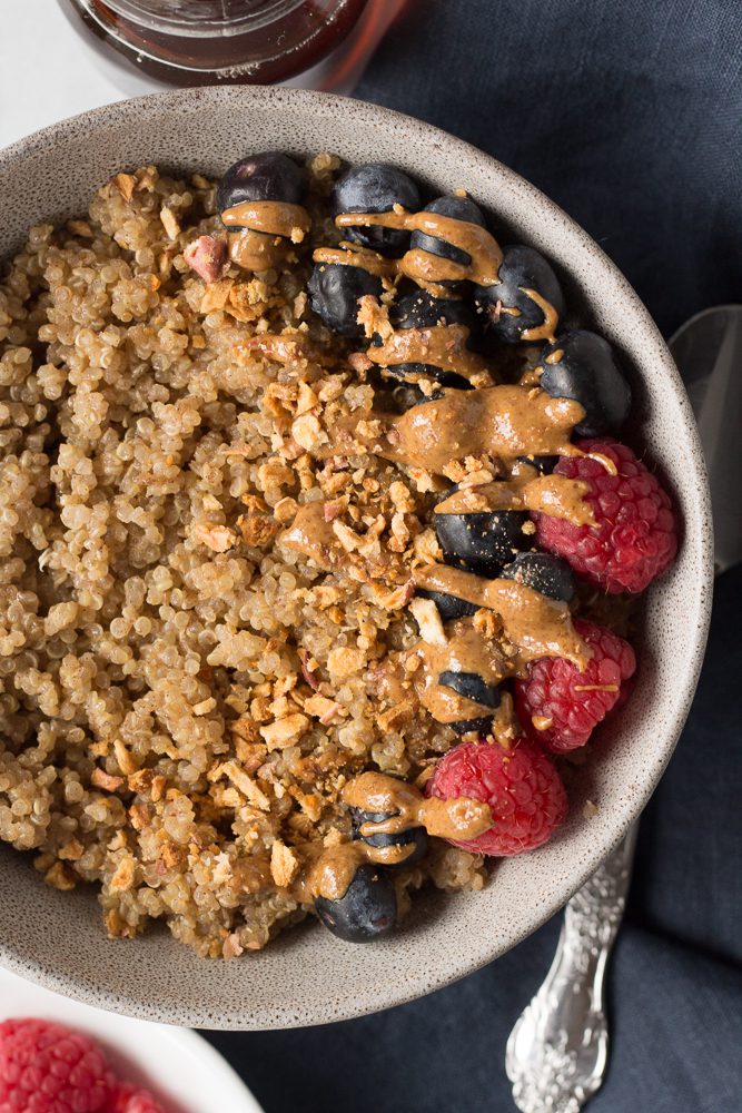 Coconut Quinoa Porridge served in a bowl with berries by Flora & Vino 