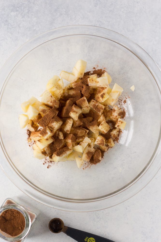 apples diced in glass bowl with cinnamon