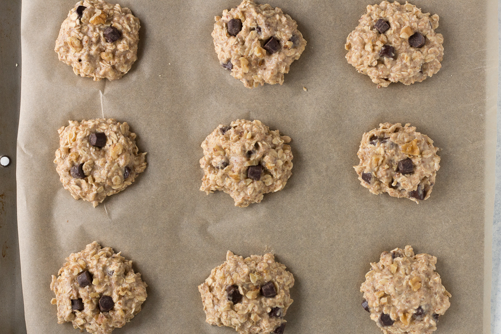 Banana Bread Breakfast Cookies on parchment lined baking sheet by Flora & Vino 