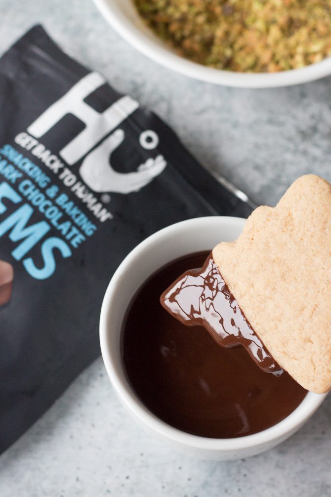 dipping sugar cookies in melted dark chocolate by Flora & Vino 