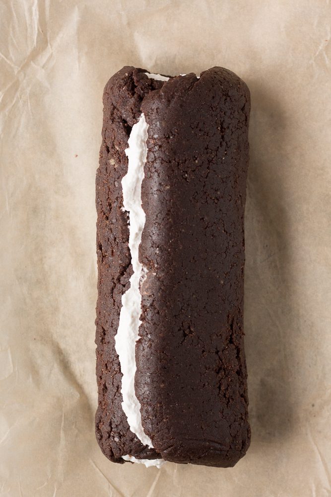 Vegan Dark Chocolate Swiss Roll rolled together on parchment paper by Flora & Vino