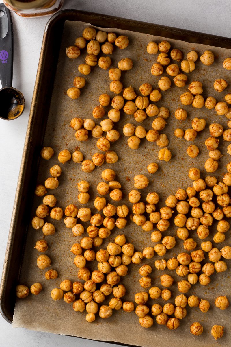 tandoori spiced chickpeas on parchment lined baking sheet