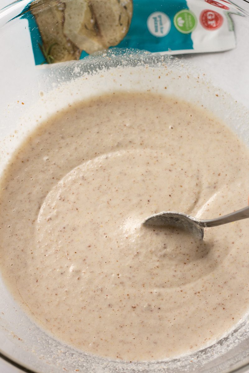 mixing grain-free flatbread batter in bowl with spoon