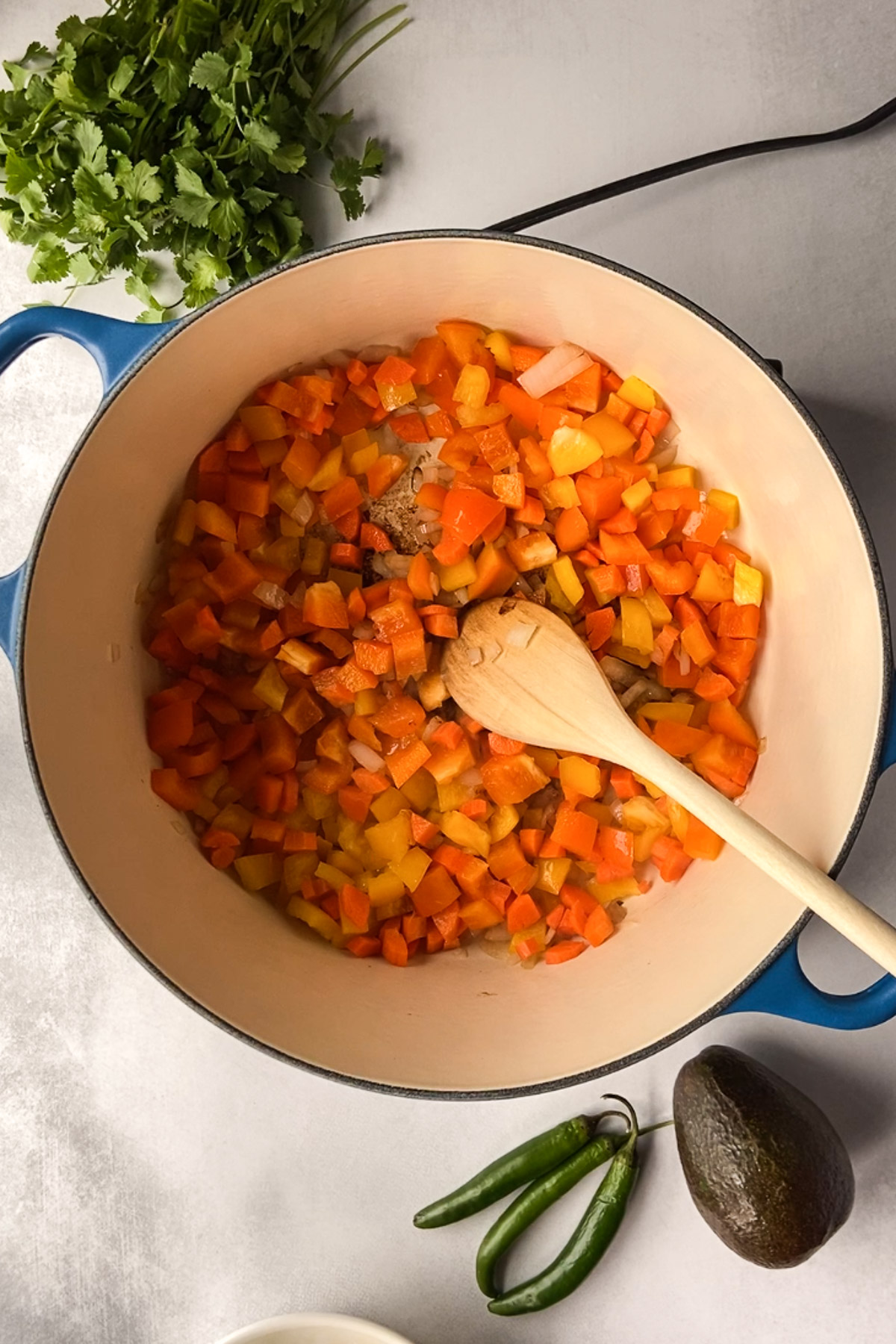 sautéeing vegetables in pot by Flora & Vino 