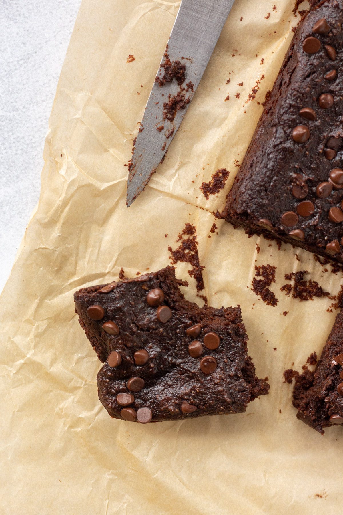 Sweet Potato SunButter Brownies cut into square with knife by Flora & Vino