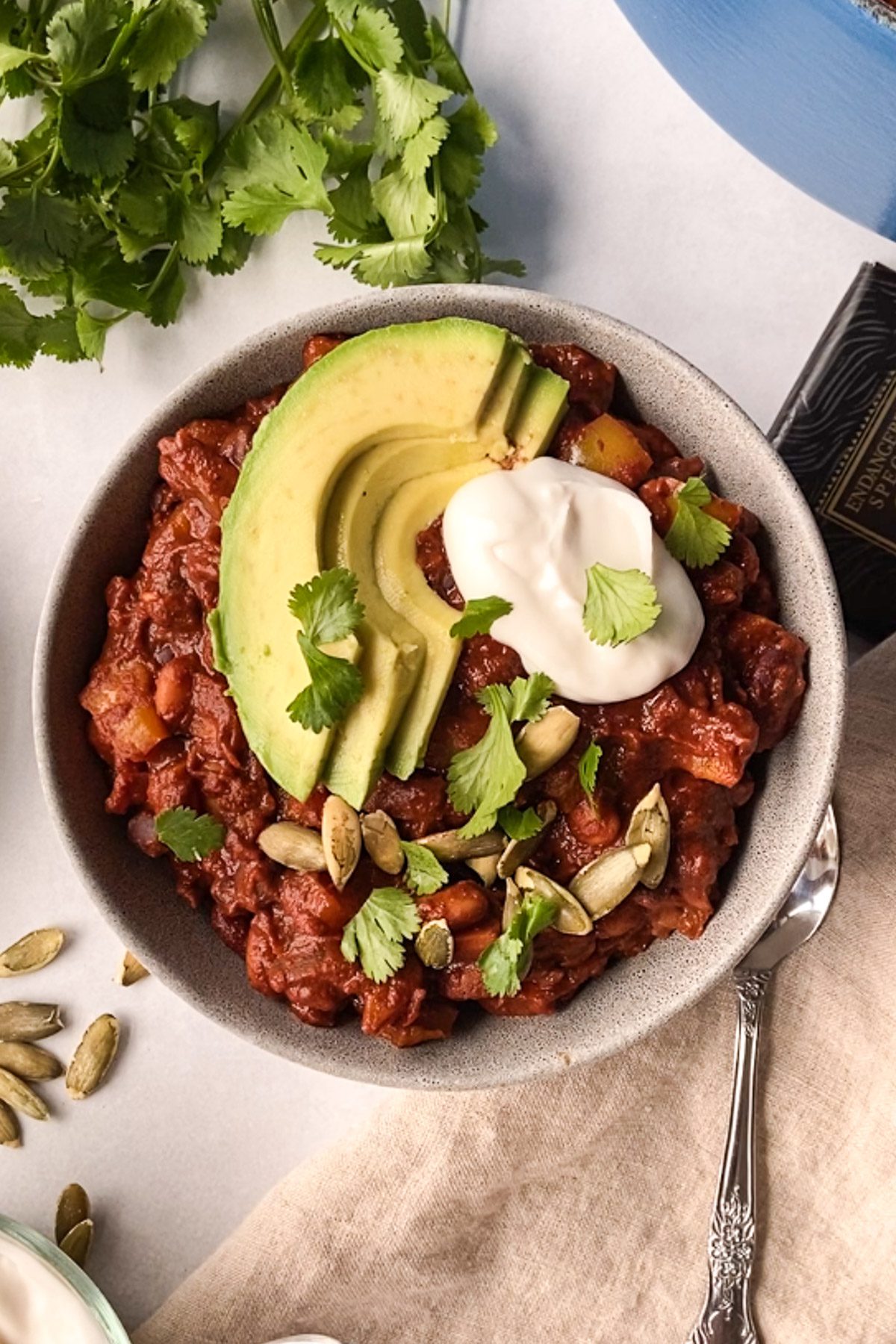 Vegan Chocolate Chili served with avocado and yogurt in a bowl by Flora & Vino