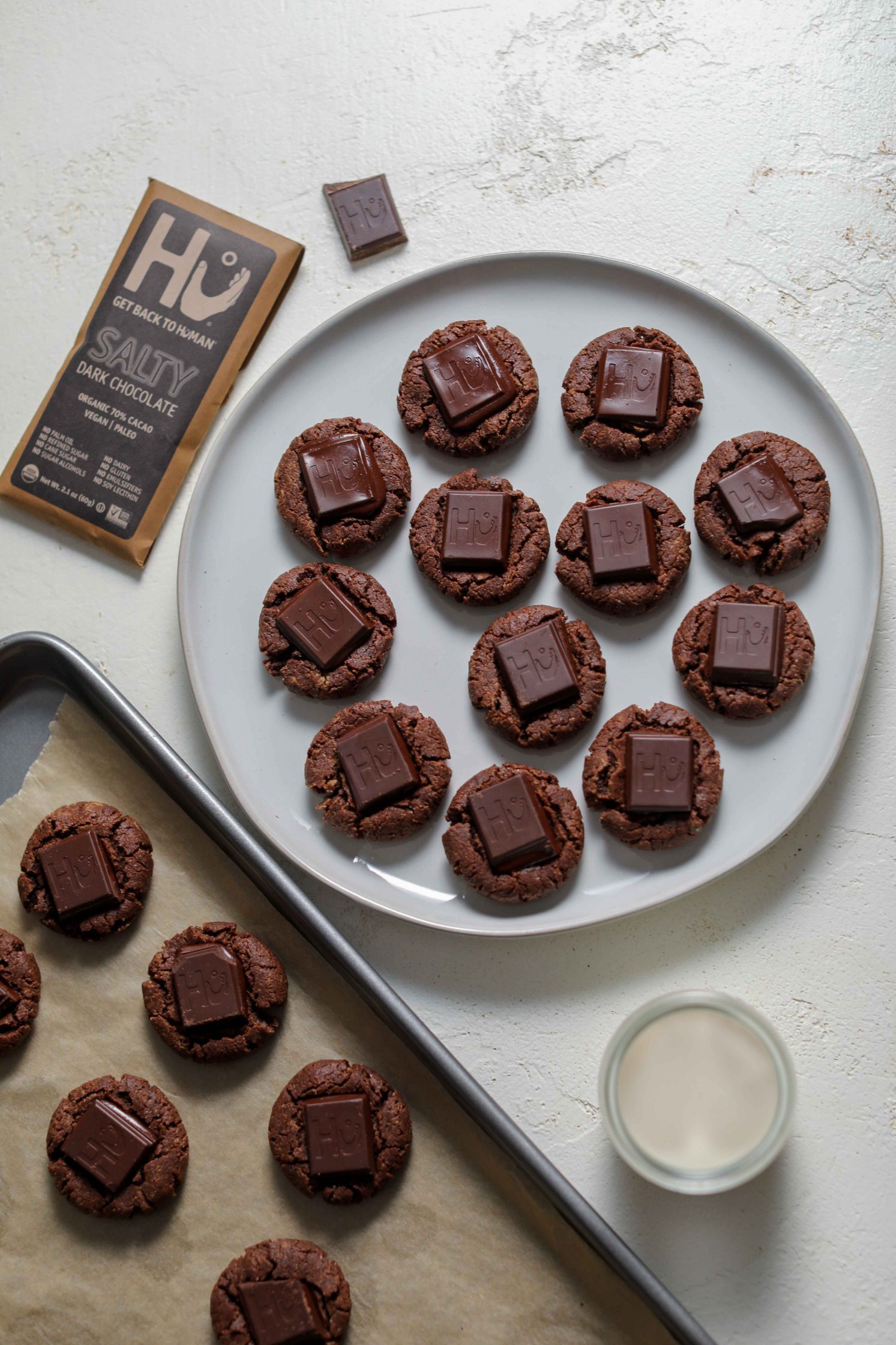 Chocolate Thumbprint Cookies served on a plate with a glass of milk by Flora & Vino 