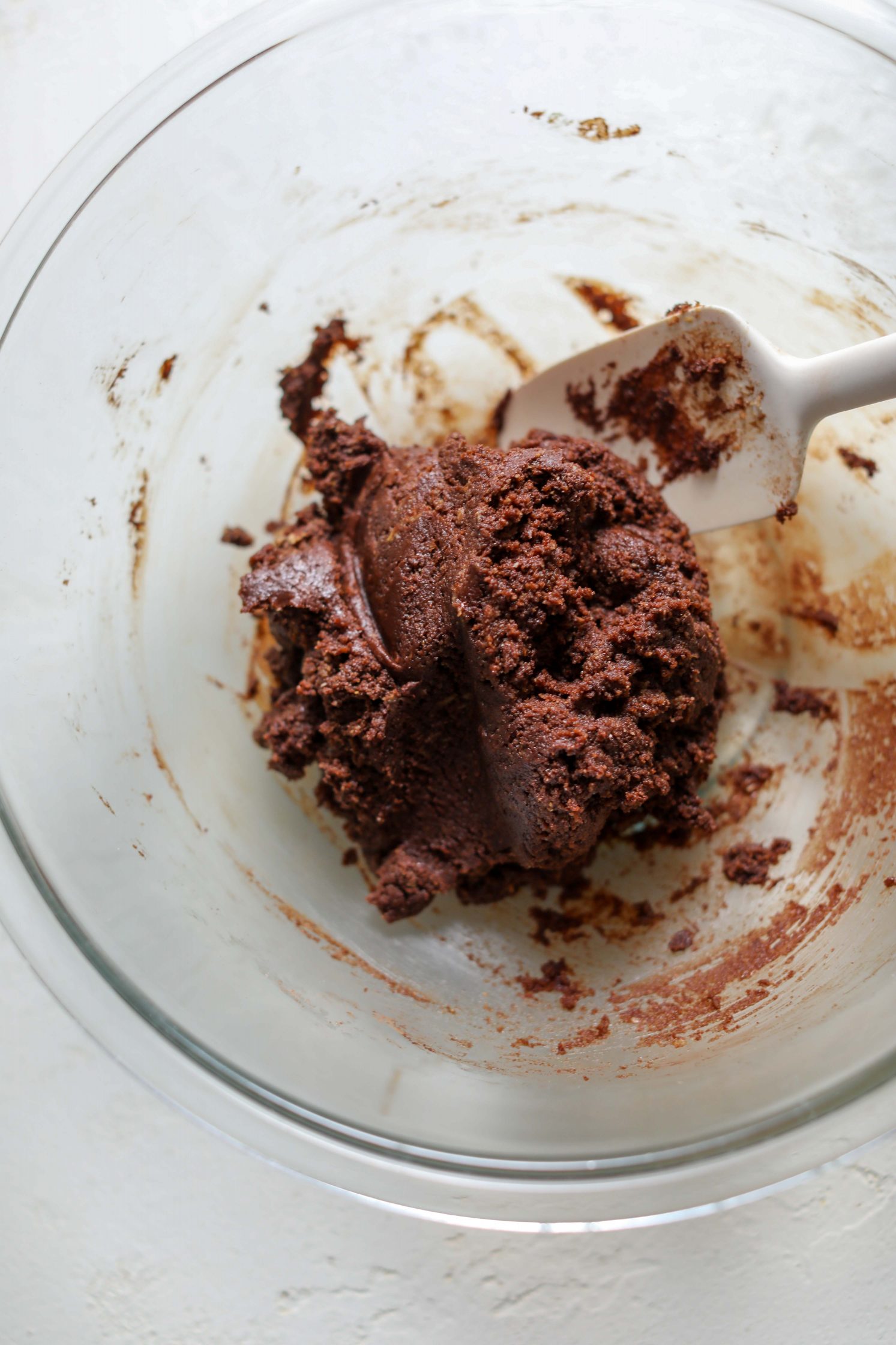 chocolate cookie batter in bowl with spatula by Flora & Vino 