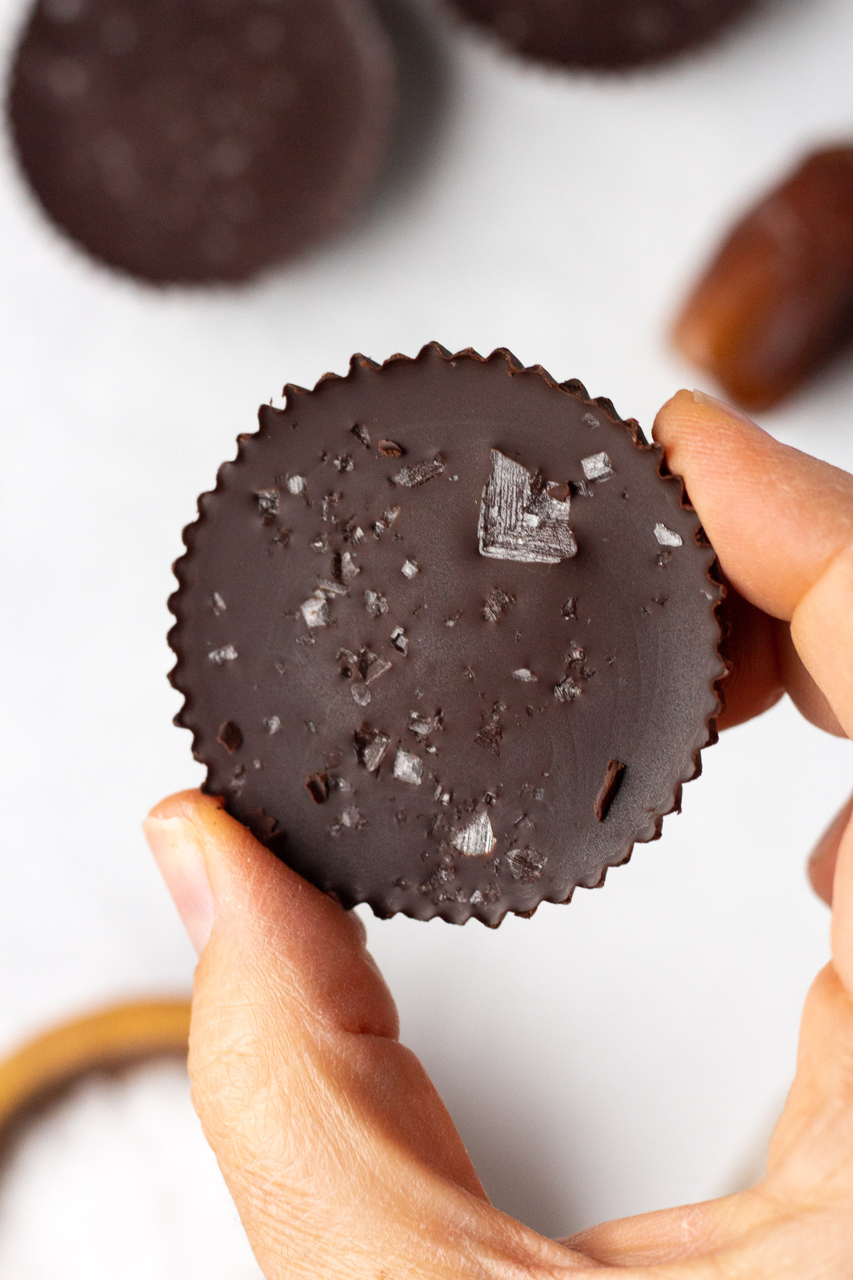 Chocolate Caramel SunButter Cups in hand by Flora & Vino
