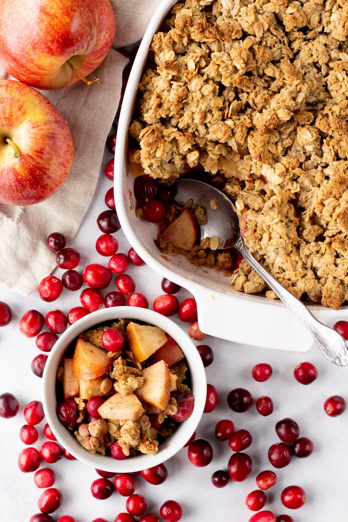 Cranberry Apple Crumble baked in casserole dish with spoon by Flora & Vino