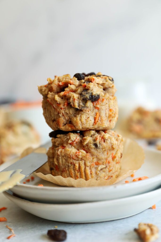 two Carrot Cake Almond Flour Muffins stacked on two plates