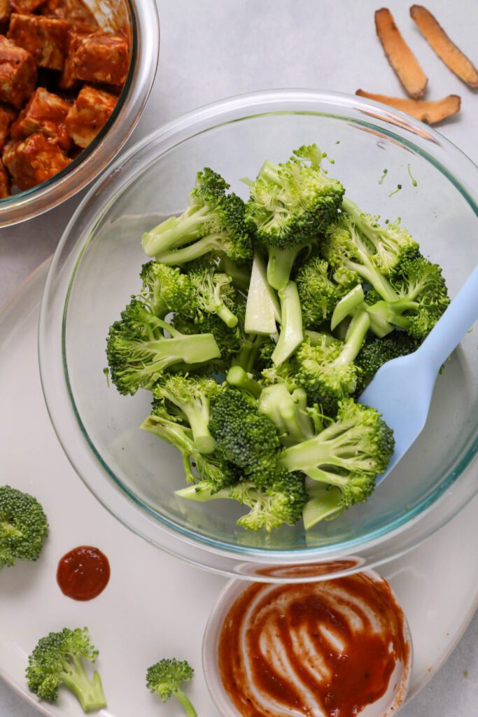 raw broccoli and marinaded tempeh and BBQ sauce by Flora & Vino