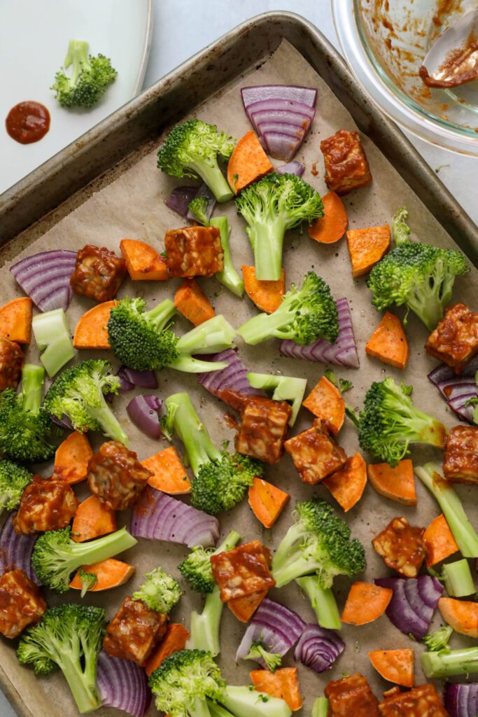 marinaded tempeh and uncooked vegetables on sheet pan by Flora & Vino