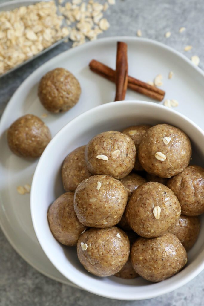 Snickerdoodle Oat Bliss Balls in a bowl by Flora & Vino