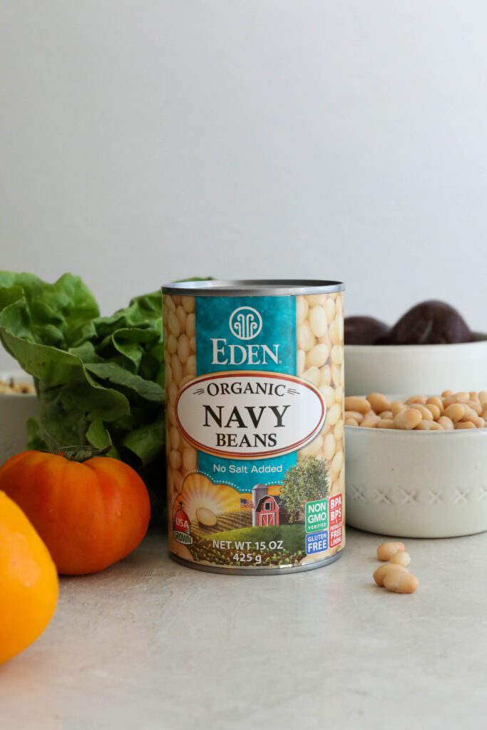 Eden Foods Organic Navy Beans with tomato, lettuce, and beets behind it