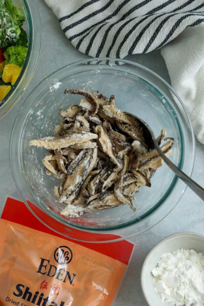 adding cornstarch to shiitake mushrooms by Flora & Vino