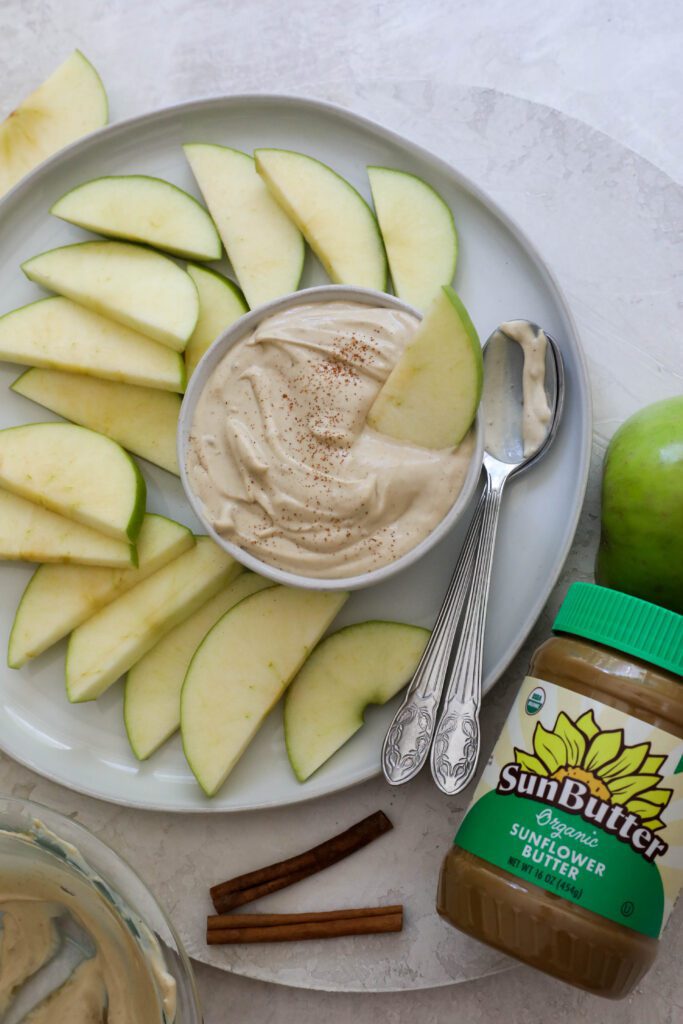 SunButter Yogurt Dip served in bowl with plate of apples by Flora & Vino