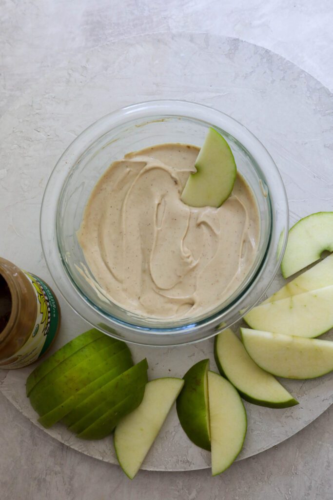 SunButter Yogurt Dip with apples dipped in by Flora & Vino