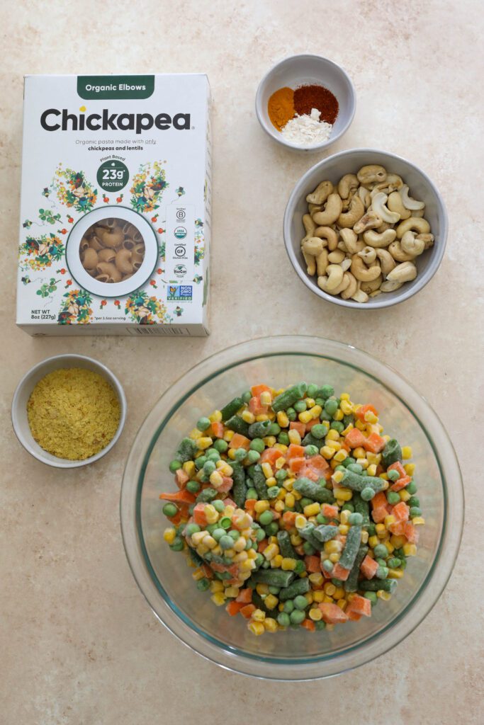 Chickapea pasta with frozen vegetables, nutritional yeast, cashews, and spices on board by Flora & Vino