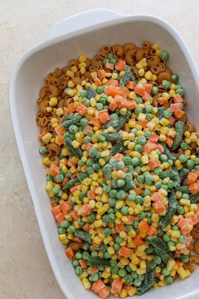 chickpea macaroni and frozen vegetables in baking dish by Flora & Vino