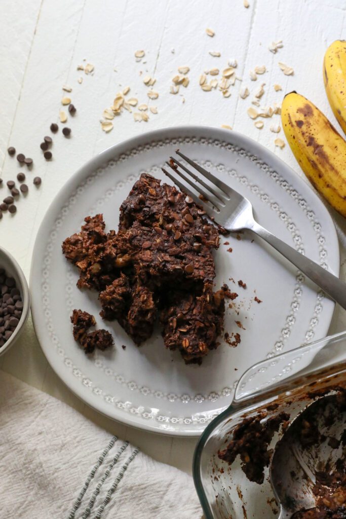 Chocolate Baked Oatmeal served on plate with a fork by Flora & Vino 