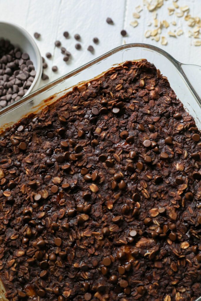 Chocolate Baked Oatmeal in baking dish with chocolate chips by Flora & Vino 