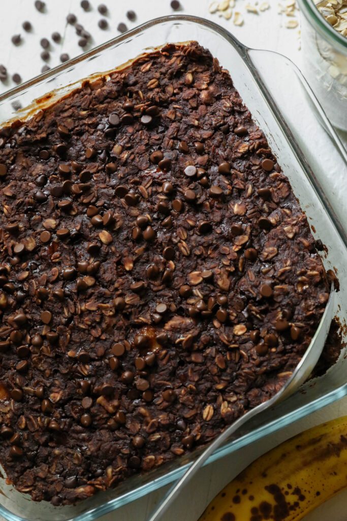 Chocolate Baked Oatmeal in baking dish with spoon by Flora & Vino 